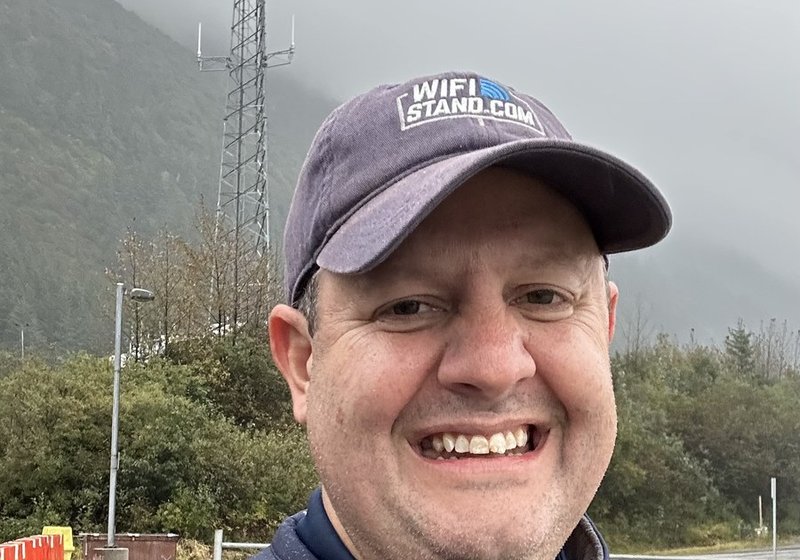 Drew Lentz in the field below a cell tower in the rain